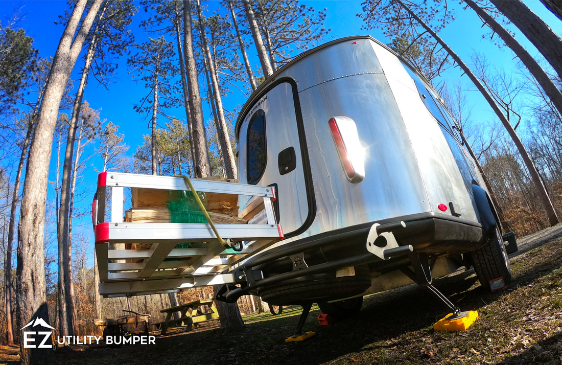Airstream Basecamp with the EZ Utility Bumper carrying a cargo basket attachment.
